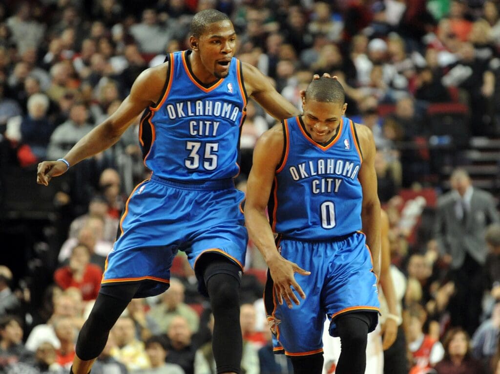 Mar. 27, 2012; Portland, OR, USA; Oklahoma City Thunder small forward Kevin Durant (35) celebrates with point guard Russell Westbrook (0) after Westbrook hit a three point shot during the fourth quarter of the game against the Portland Trail Blazers at the Rose Garden. Westbrook scored 32 points as the Thunder won the game 109-95.