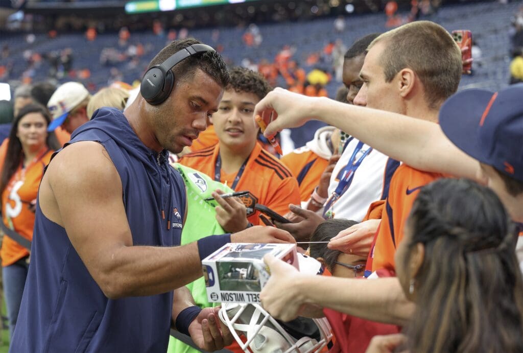 Dec 3, 2023; Houston, Texas, USA; Denver Broncos quarterback Russell Wilson (3) signs autographs for fans before playing against the Houston Texans at NRG Stadium.