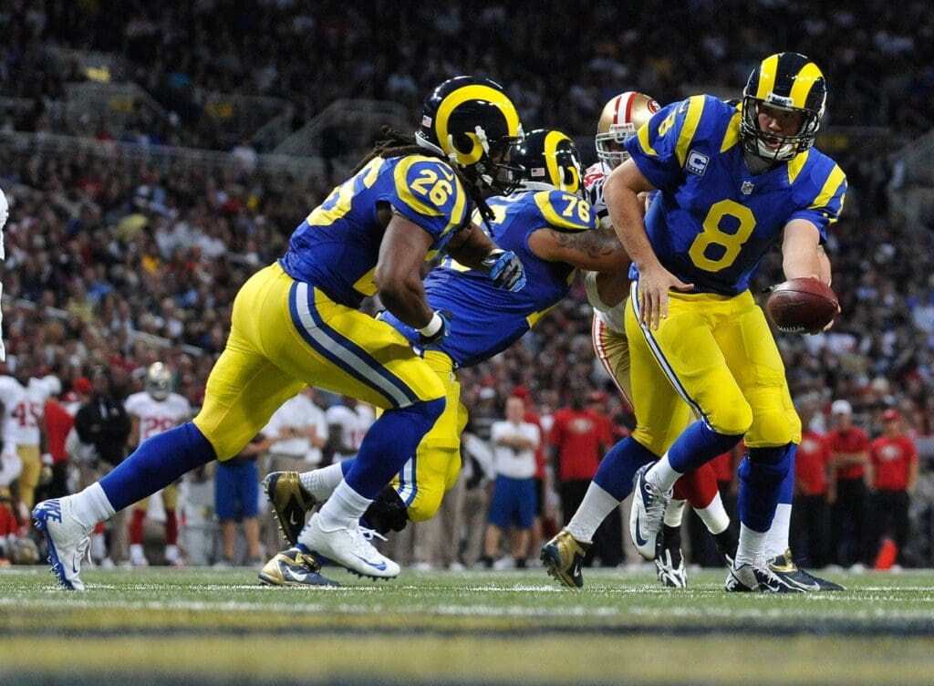December 2, 2012; St. Louis, MO, USA; St. Louis Rams quarterback Sam Bradford (8) hands off to running back Daryl Richardson (26) during the first half at the Edward Jones Dome. St. Louis defeated San Francisco 16-13 in overtime.