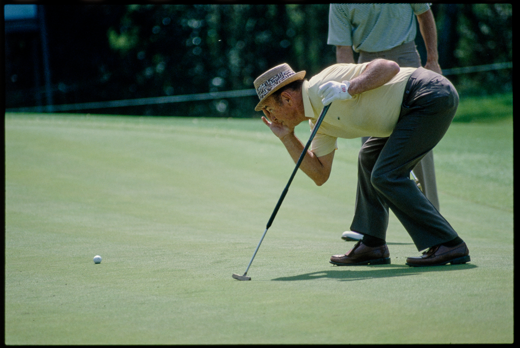 04/07/1983; Augusta, Georgia, USA; Sam Snead lining up putt at the Augusta National Golf Course during the 1983 Masters.