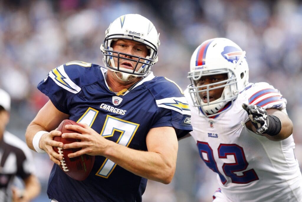December 11, 2011, San Diego, CA: San Diego Chargers quarterback Philip Rivers (17) is chased by Buffalo Bills defensive end Alex Carrington (92) as he runs the ball at Qualcomm Stadium. The Chargers beat the Bills 37-10.