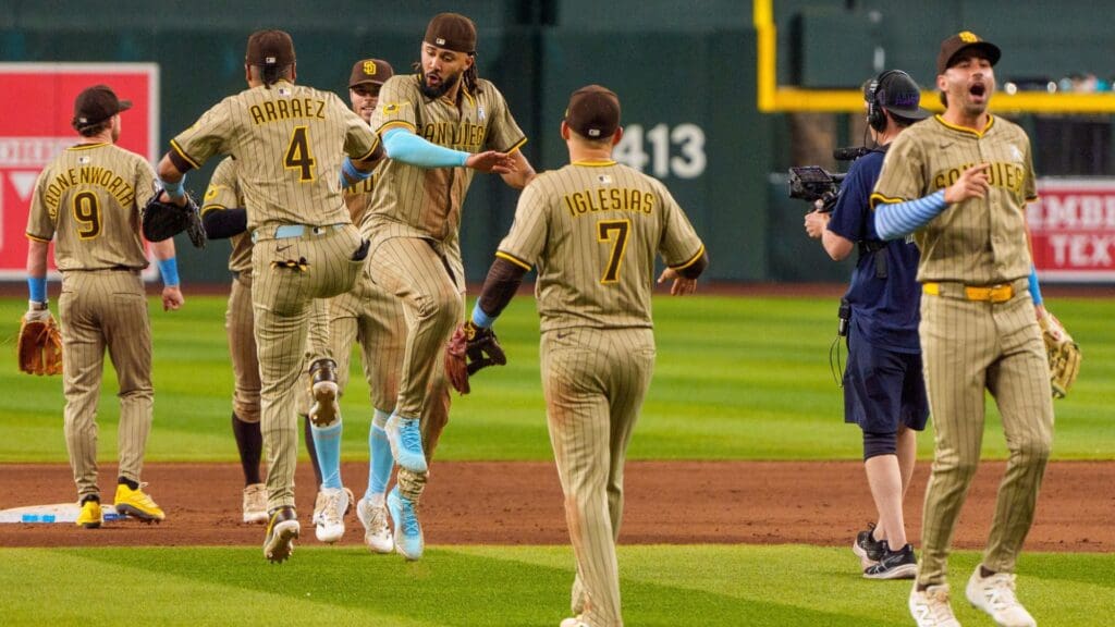Jun 15, 2025; Phoenix, Arizona, USA; San Diego Padres outfielder Fernando Tatis Jr. (23) and infielder Luis Arraez (4) celebrate with their team after a victory against the Arizona Diamondbacks. at Chase Field.