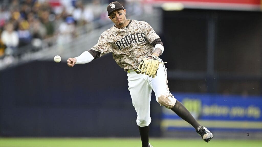 Mar 30, 2025; San Diego, California, USA; San Diego Padres third baseman Manny Machado (13) throws to first base as he turns a double play during the eighth inning against the Atlanta Braves at Petco Park.