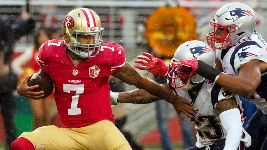Nov 20, 2016; Santa Clara, CA, USA; San Francisco 49ers quarterback Colin Kaepernick (7) tries to hold off New England Patriots strong safety Patrick Chung (23) and defensive end Trey Flowers (98) before being sacked during the first quarter at Levi's Stadium.