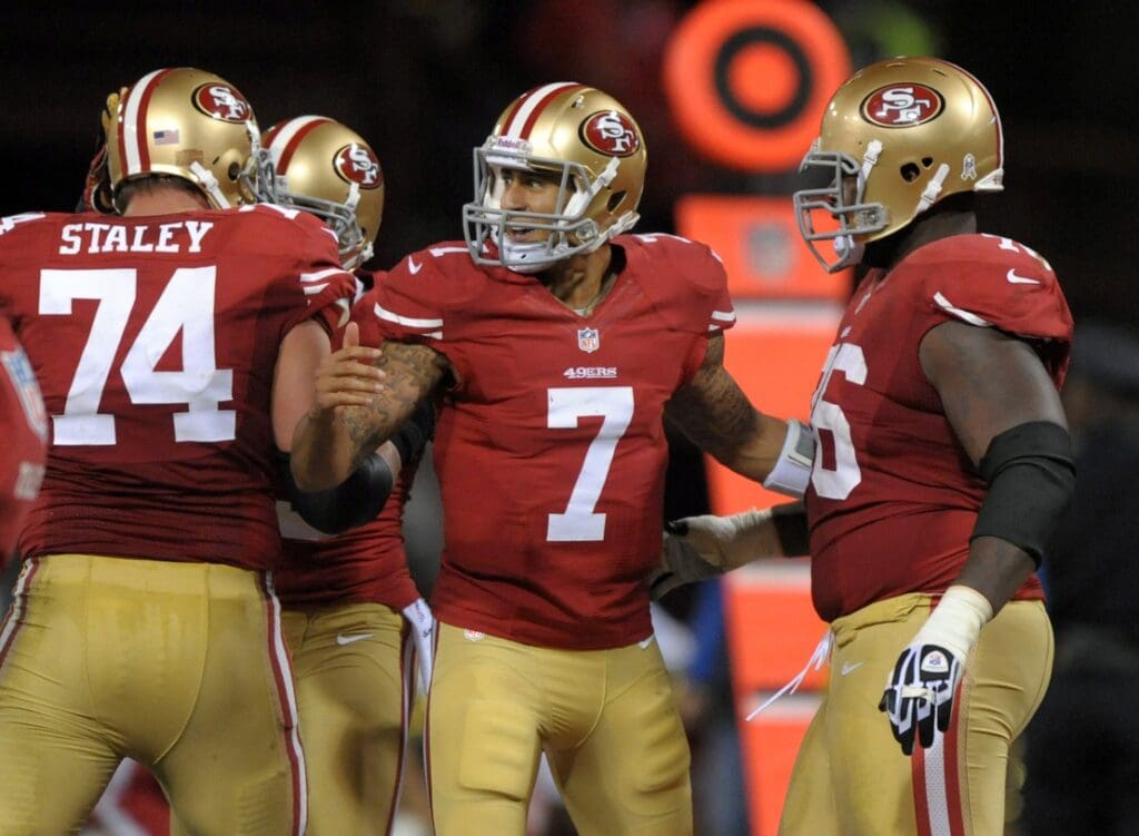 San Francisco 49ers quarterback Colin Kaepernick (7) celebrates with tackles Joe Staley (74) and Anthony Davis (76)