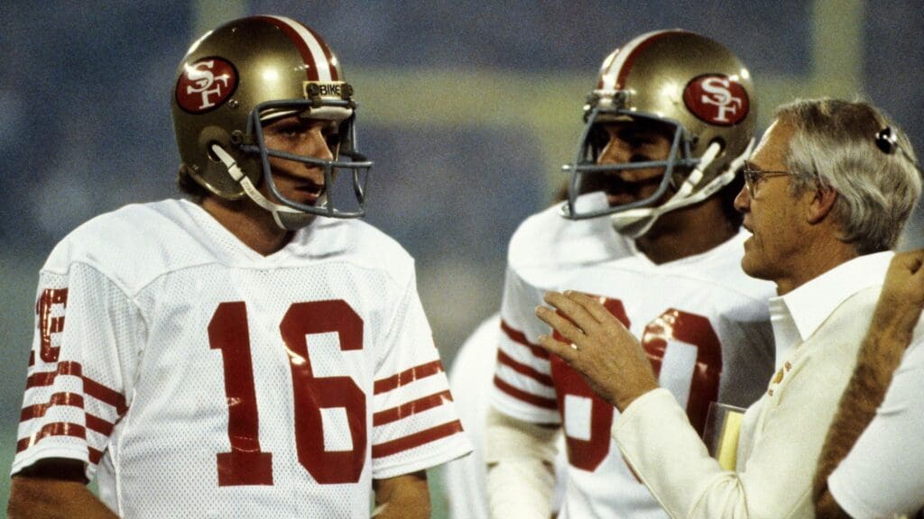 Jan 24, 1982; Pontiac, MI, USA; FILE PHOTO; San Francisco 49ers quarterback Joe Montana (16) talks with Eason Ramson (80) and Bill Walsh (right) on the sideline against the Cincinnati Bengals during Super Bowl XVI at the Pontiac Superdome. The 49ers defeated the Bengals 26-21.