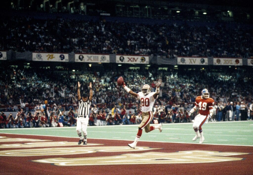 Jan 28, 1990; New Orleans, LA, USA; FILE PHOTO; San Francisco 49ers receiver Jerry Rice (80) scores a touchdown during Super Bowl XXIV against the Denver Broncos at the Louisiana Superdome. The 49ers won 55-10.