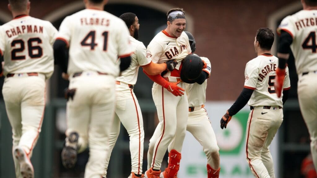 Apr 26, 2025; San Francisco, California, USA; San Francisco Giants pinch hitter Patrick Bailey (facing) is mobbed by his teammates after hitting a game-winning single against the Texas Rangers during the ninth inning at Oracle Park.