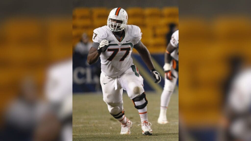 Nov 29, 2013; Pittsburgh, PA, USA; Miami Hurricanes offensive linesman Seantrel Henderson (77) blocks at the line of scrimmage against the Pittsburgh Panthers during the third quarter at Heinz Field. Miami won 41-31.