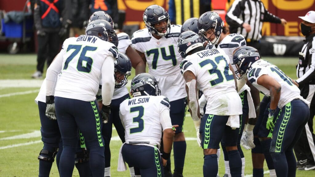 Dec 20, 2020; Landover, Maryland, USA; Seattle Seahawks quarterback Russell Wilson (3) huddles with teammates against the Washington Football Team at FedExField.