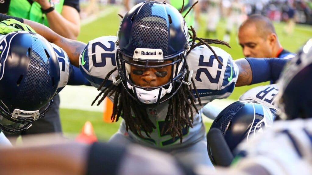 Oct 17, 2013; Phoenix, AZ, USA; Seattle Seahawks cornerback Richard Sherman (25) in the huddle with teammates against the Arizona Cardinals at University of Phoenix Stadium.