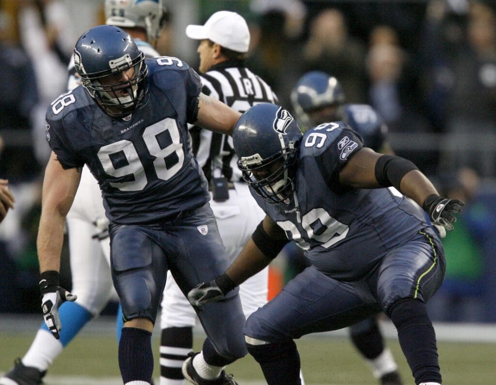 Jan 22, 2006; Seattle, WA, USA; Seattle Seahawks defensive tackle (99) Rocky Bernard celebrates with teammate (98) Grant Wistrom against the Carolina Panthers during the 2nd quarter of the NFC Championship game at Qwest Field in Seattle, Washington