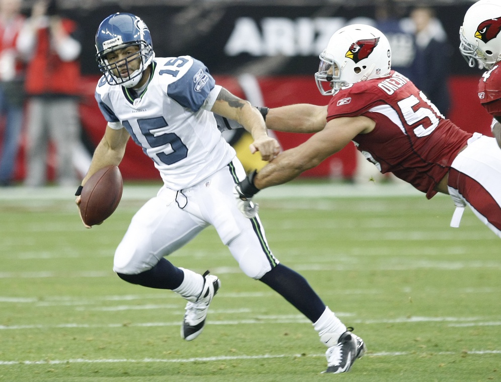 Dec. 28, 2008; Glendale, AZ, USA; Seattle Seahawks quarterback Seneca Wallace (15) runs from the Arizona Cardinals linebacker (56) Chike Okeafer (56) in the second quarter at University of Phoenix Stadium. 