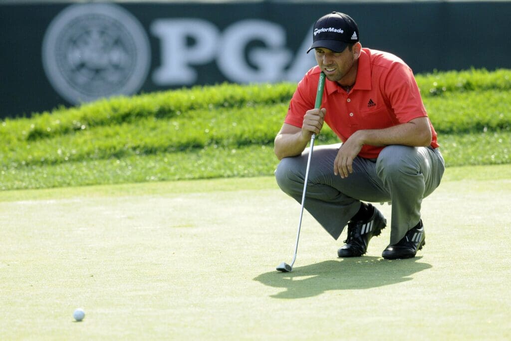 Aug 9, 2013; Rochester, NY, USA; Sergio Garcia lines up his putt on the 18th green during the second round of the 95th PGA Championship at Oak Hill Country Club.