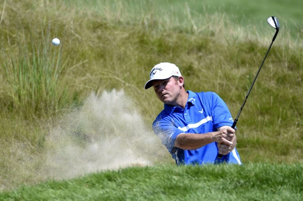 Aug 14, 2015; Sheboygan, WI, USA; Shaun Micheel plays from a bunker on the 18th hole during the second round of the 2015 PGA Championship golf tournament at Whistling Straits.