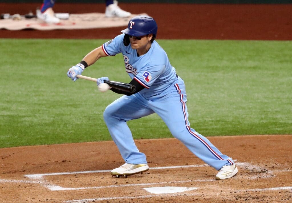 Sep 27, 2020; Arlington, Texas, USA; Texas Rangers designated hitter Shin-Soo Choo (17) hits a bunt single during the first inning against the Houston Astros at Globe Life Field.