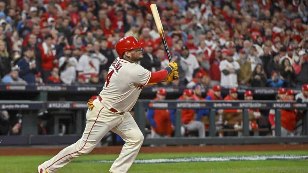 Oct 8, 2022; St. Louis, Missouri, USA; St. Louis Cardinals catcher Yadier Molina (4) hits a single for his final postseason at bat in the ninth inning against the Philadelphia Phillies during game two of the Wild Card series for the 2022 MLB Playoffs at Busch Stadium.