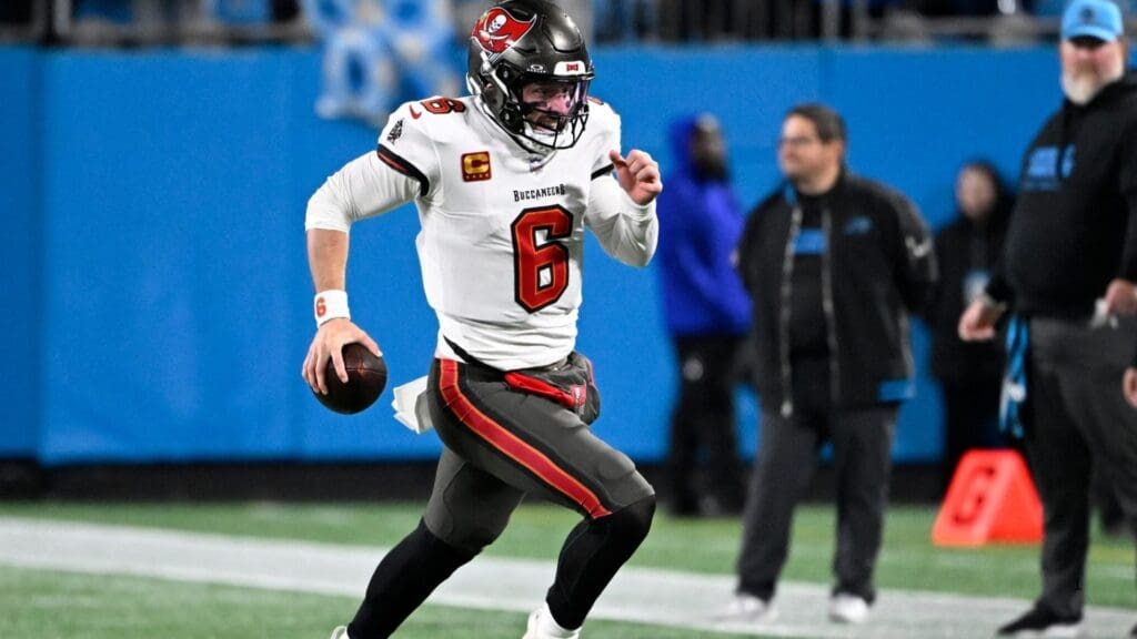 Dec 1, 2024; Charlotte, North Carolina, USA; Tampa Bay Buccaneers quarterback Baker Mayfield (6) runs for a firts down in overtime at Bank of America Stadium.