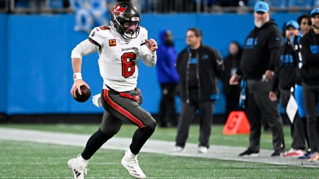 Dec 1, 2024; Charlotte, North Carolina, USA; Tampa Bay Buccaneers quarterback Baker Mayfield (6) runs for a firts down in overtime at Bank of America Stadium.