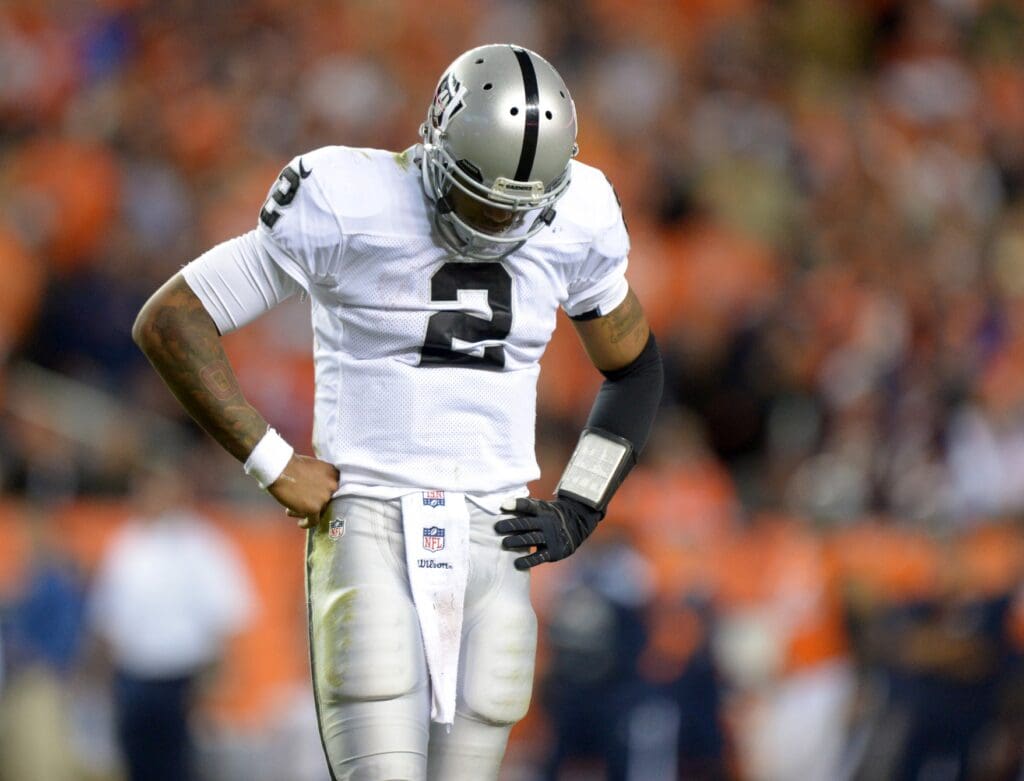 Sep 23, 2013; Denver, CO, USA; Oakland Raiders quarterback Terrelle Pryor (2) reacts during the game against the Denver Broncos at Sports Authority Field at Mile High. The Broncos defeated the Raiders 37-21.
