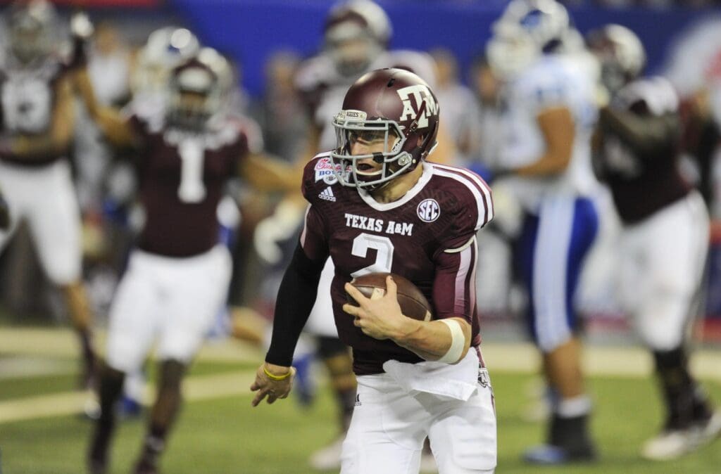Dec 31, 2013; Atlanta, GA, USA; Texas A&M Aggies quarterback Johnny Manziel (2) carries the ball for a three yard touchdown against the Duke Blue Devils in the 2013 Chick-fil-a Bowl at the Georgia Dome.