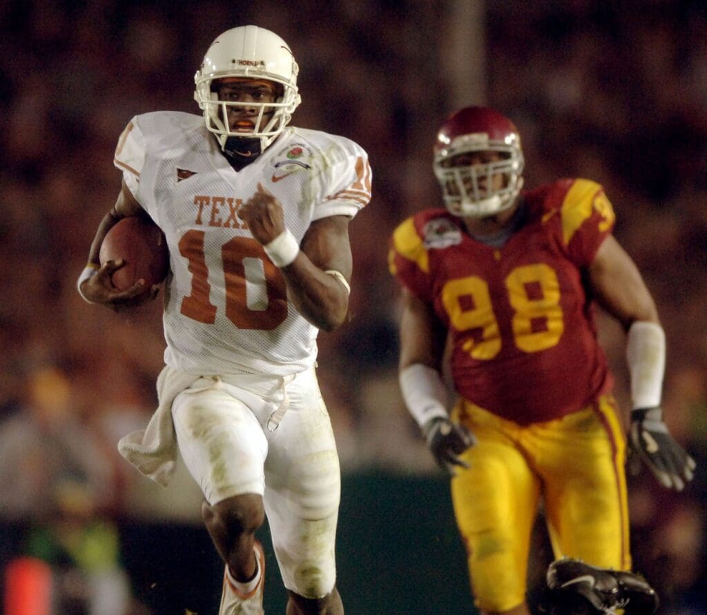 Jan 4, 2006; Pasadena, CA, USA; Texas Longhorns quarterback (10) Vince Young runs past Southern California Trojans defensive tackle (98) LaJuan Ramsey during the 4th quarter of the Rose Bowl Game at the Rose Bowl in Pasadena, California.