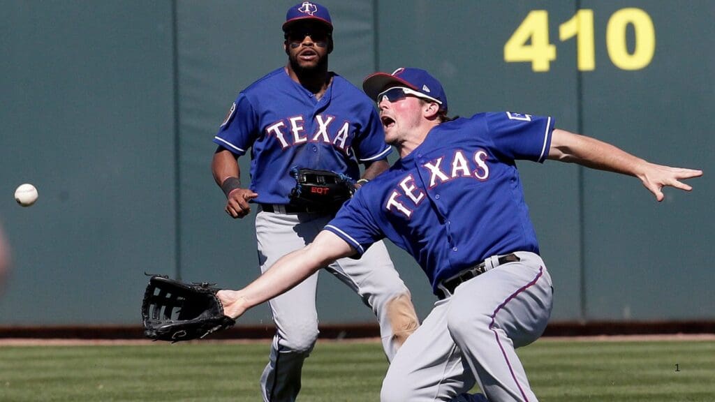 Mar 2, 2017; Mesa, AZ, USA; Texas Rangers right fielder Travis Snider (45) slides for the ball in the third inning against the Oakland Athletics during a spring training game at HoHoKam Stadium.