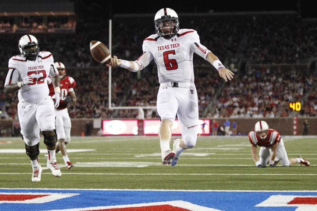 Aug 30, 2013; Dallas, TX, USA; Texas Tech Red Raiders quarterback Baker Mayfield (6) scores a touchdown in the fourth quarter of the game against the Southern Methodist Mustangs at Gerald J. Ford Stadium. Texas Tech won 41-23.
