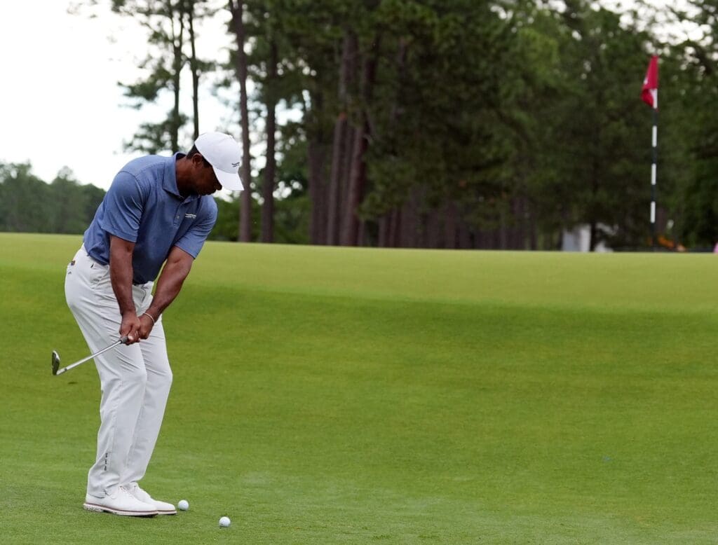 Jun 10, 2024; Pinehurst, North Carolina, USA; Tiger Woods chips up onto the 10th green during a practice round for the U.S. Open golf tournament at Pinehurst No. 2