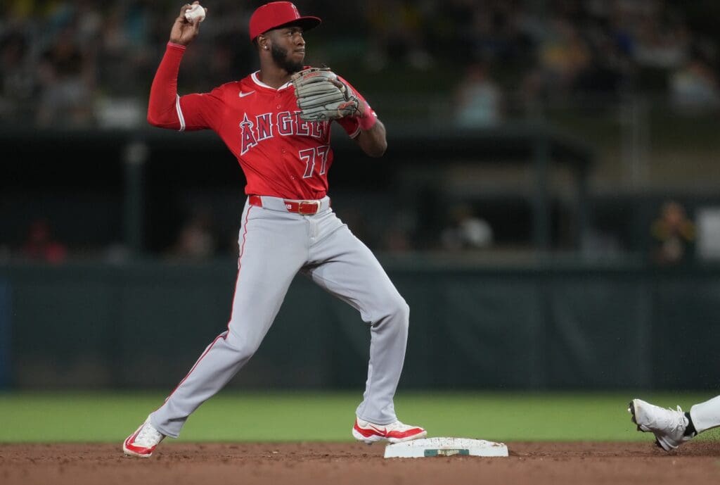 May 21, 2025; West Sacramento, California, USA; Los Angeles Angels second baseman Tim Anderson (77) turns a double play against the Athletics in the sixth inning at Sutter Health Park.