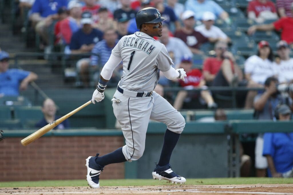 Jul 31, 2019; Arlington, TX, USA; Seattle Mariners left fielder Tim Beckham (1) singles in a run in the first inning against the Texas Rangers at Globe Life Park in Arlington.