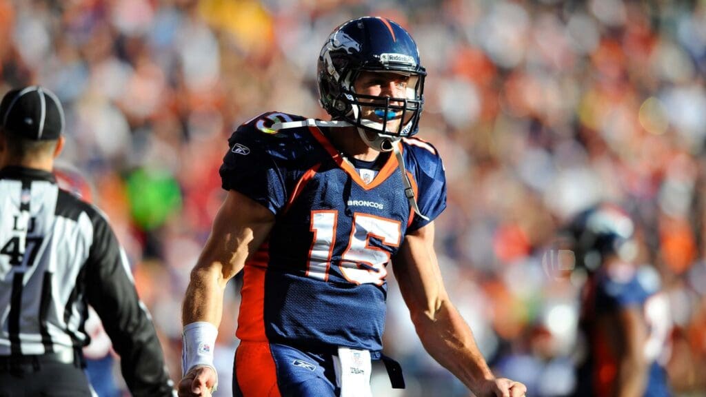 Dec 18 2011; Denver, CO, USA; Denver Broncos quarterback Tim Tebow (15) reacts after a touchdown in the the first quarter of the game against the New England Patriots at Sports Authority Field.