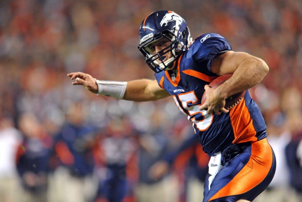 Nov 17, 2011; Denver, CO, USA; Denver Broncos quarterback Tim Tebow (15) runs for a 20 yard touchdown late in the the fourth quarter against New York Jets at Sports Authority Field.