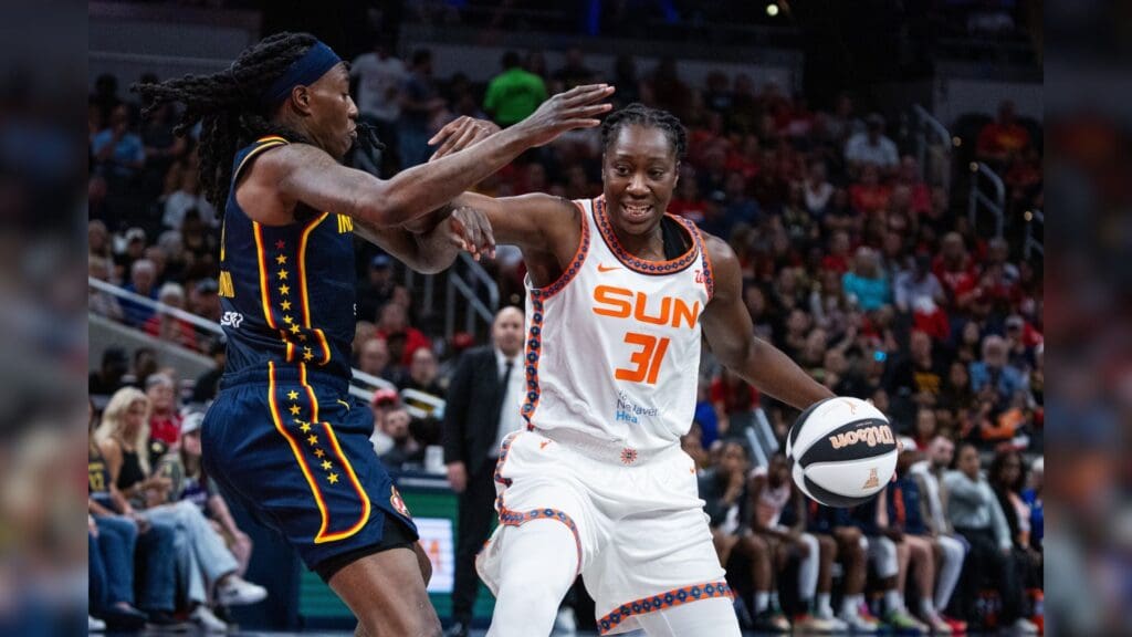 Jun 17, 2025; Indianapolis, Indiana, USA; Connecticut Sun center Tina Charles (31) dribbles the ball while Indiana Fever forward Natasha Howard (6) defends in the second half at Gainbridge Fieldhouse.