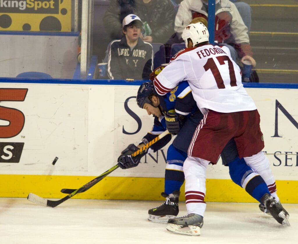Feb 24, 2009; St. Louis, MO, USA; Phoenix Coyotes left wing Todd Fedoruk (17) checks St. Louis Blues right wing Cam Janssen (55) during the third period at the Scottrade Center. The Blues defeated the Coyotes 2-1.