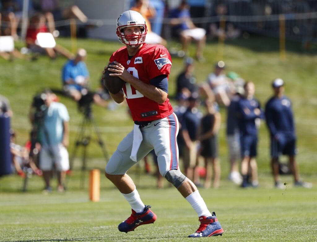 Jul 30, 2016; Foxborough, MA, USA; New England Patriots quarterback Tom Brady (12) looks for a receiver during training camp at Gillette Stadium.