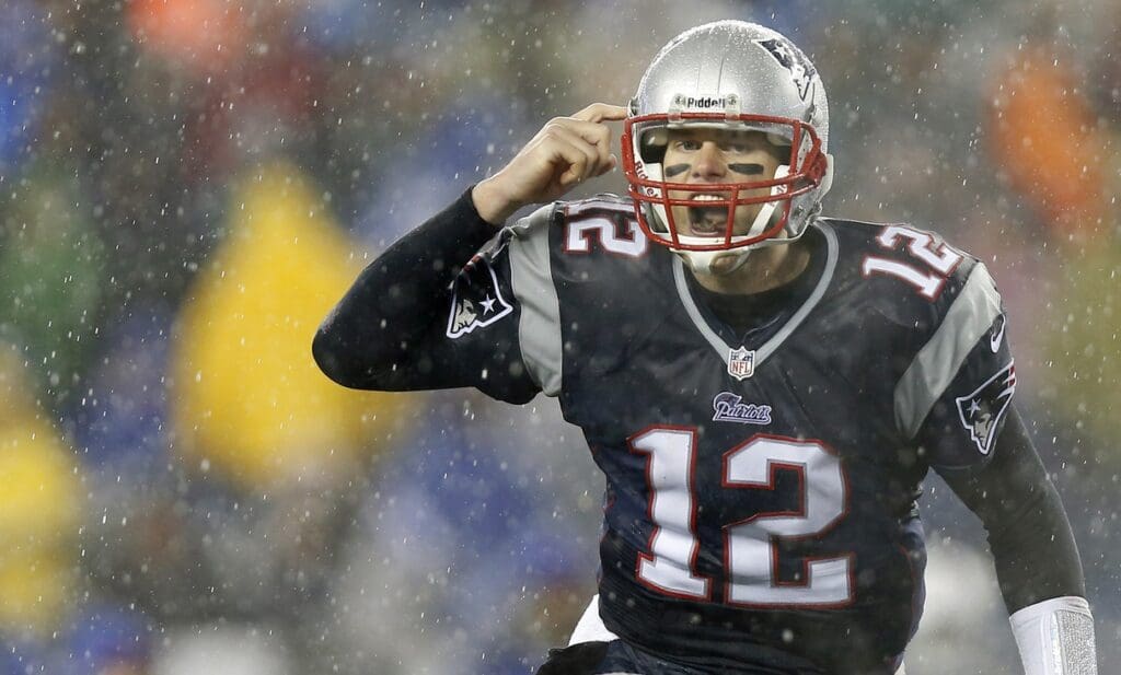 Dec 29, 2013; Foxborough, MA, USA; New England Patriots quarterback Tom Brady (12) signals his teammates at the line of scrimmage during the second quarter against the Buffalo Bills at Gillette Stadium.
