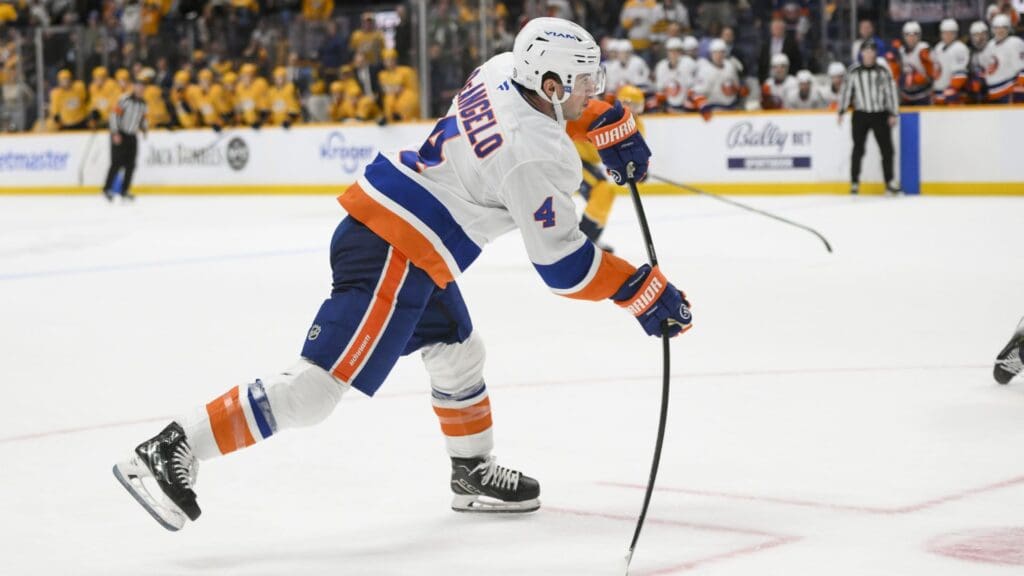 Apr 8, 2025; Nashville, Tennessee, USA; New York Islanders defenseman Tony DeAngelo (4) takes a shot on goal against the Nashville Predators during the over time period at Bridgestone Arena.