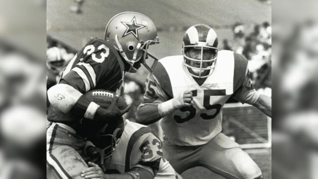 Jan 7, 1979; Los Angeles, CA, USA; FILE PHOTO; Dallas Cowboys running back Tony Dorsett (33) runs with the ball against Los Angeles Rams linebacker Jim Youngblood (53) and Carl Ekern (55) during the 1978 NFC Championship at Memorial Coliseum. The Cowboys defeated the Rams 28-0.