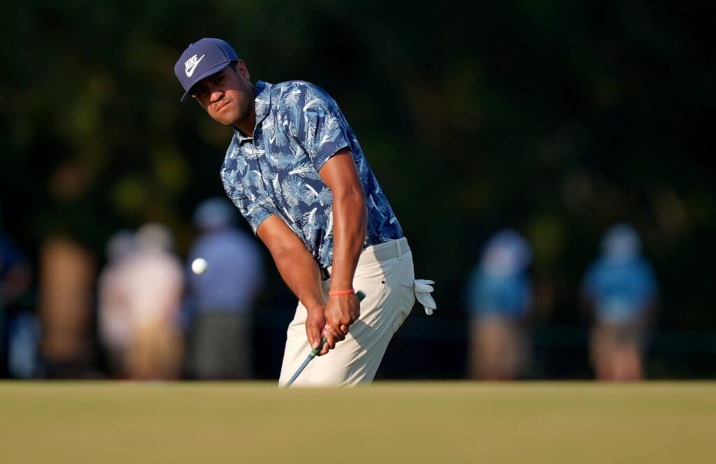 Jun 14, 2024; Pinehurst, North Carolina, USA; Tony Finau chips on the 18th hole during the second round of the U.S. Open golf tournament at Pinehurst No. 2