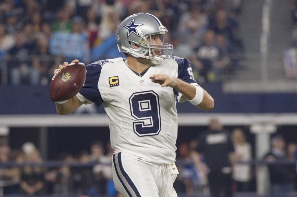 Nov 26, 2015; Arlington, TX, USA; Dallas Cowboys quarterback Tony Romo (9) rolls out to pass against the Carolina Panthers during the first quarter of an NFL game on Thanksgiving at AT&T Stadium