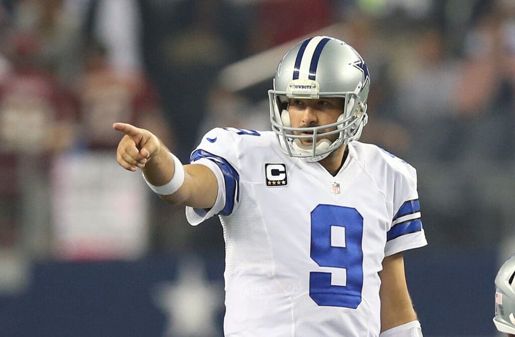 Oct 13, 2013; Arlington, TX, USA; Dallas Cowboys quarterback Tony Romo (9) points as he directs his team in the fourth quarter against the Washington Redskins at AT&T Stadium. The Dallas Cowboys beat the Washington Redskins 31-16.
