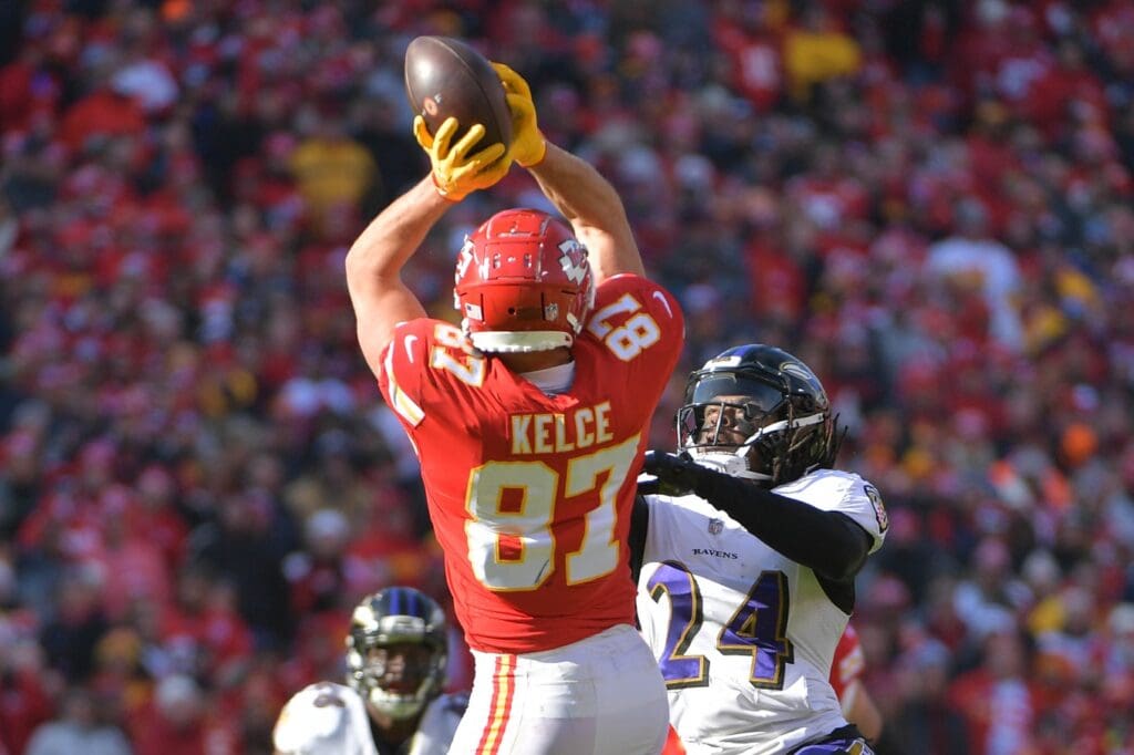 Dec 9, 2018; Kansas City, MO, USA; Kansas City Chiefs tight end Travis Kelce (87) catches a pass as Baltimore Ravens cornerback Brandon Carr (24) defends during the first half at Arrowhead Stadium