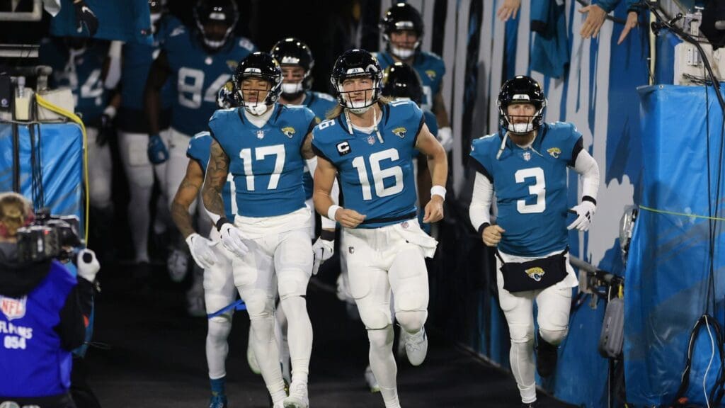 Jacksonville Jaguars quarterback Trevor Lawrence (16) takes to the field with teammates before an NFL first round playoff football matchup between the Jacksonville Jaguars and the Los Angeles Chargers Saturday, Jan. 14, 2023 at TIAA Bank Field in Jacksonville, Fla.