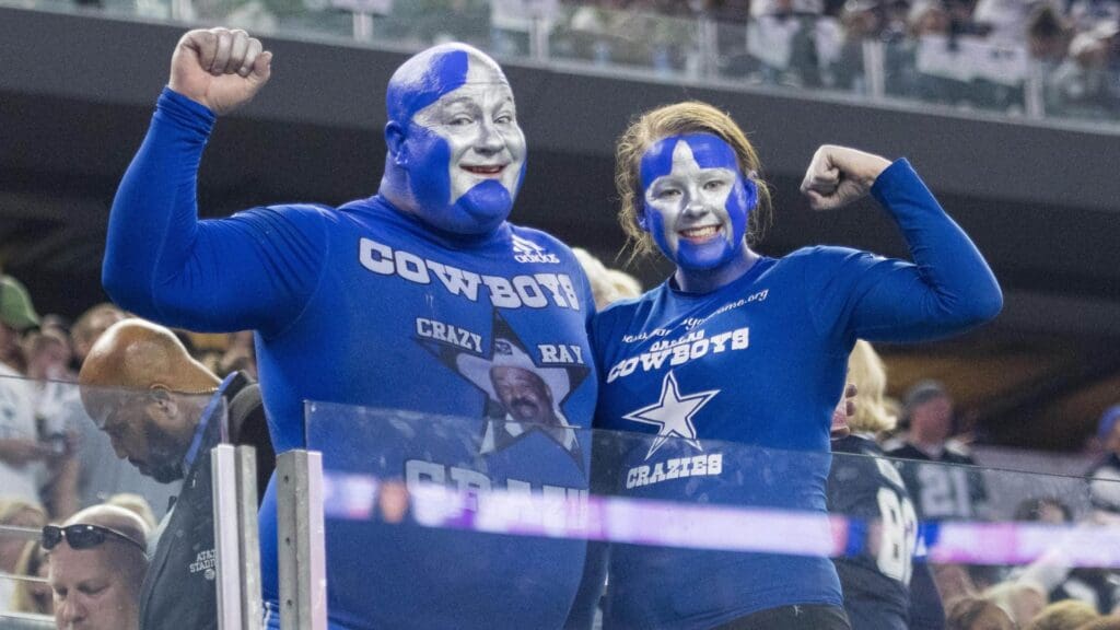 Nov 24, 2016; Arlington, TX, USA; Two Dallas Cowboys fans cheers for their team during the second half of the game against the Washington Redskins at AT&T Stadium. The Cowboys defeat the Redskins 31-26