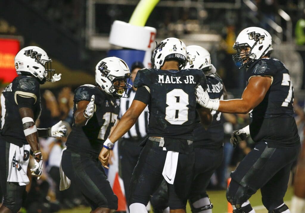 Dec 1, 2018; Orlando, FL, USA; UCF Knights quarterback Darriel Mack Jr. (8) celebrates with teammates after a touchdown during the second half against the Memphis Tigers at Spectrum Stadium.