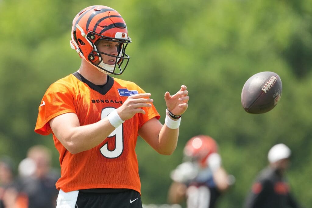 Jun 10, 2025; Cincinnati, OH, USA; Cincinnati Bengals quarterback Joe Burrow (9) catches a ball during practice at Paycor Stadium. Mandatory Credit: Kareem Elgazzar-Imagn Images