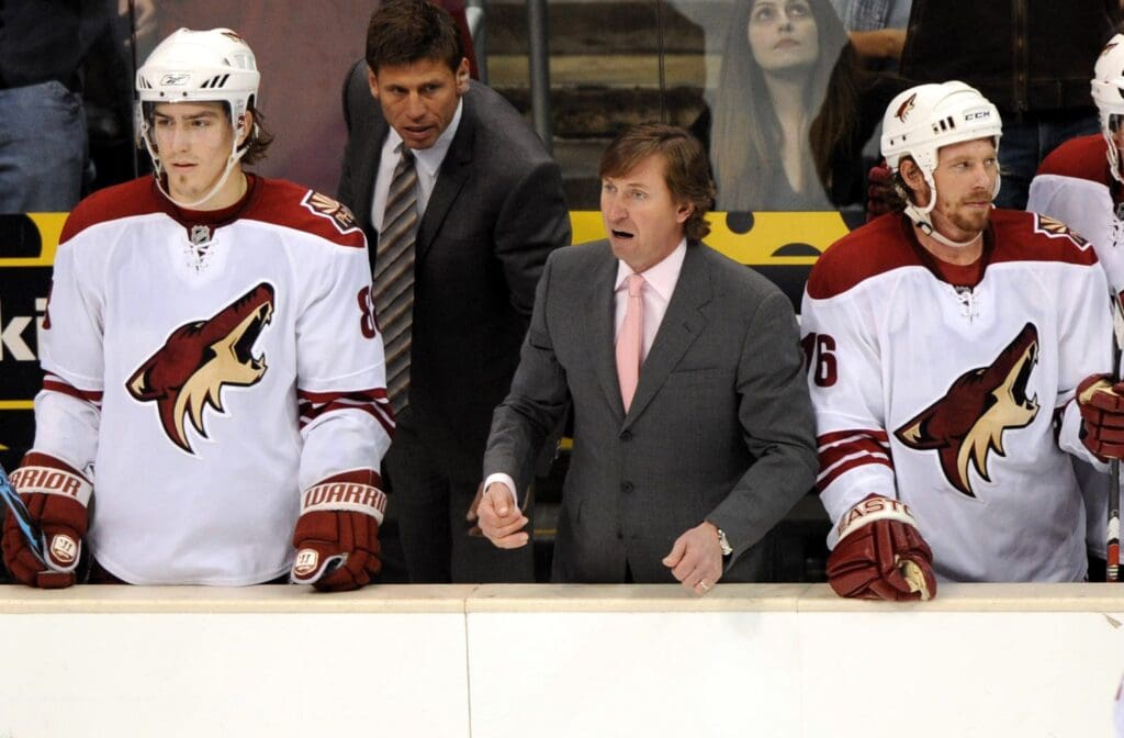 Feb 18, 2008; Los Angeles, CA, USA; Phoenix Coyotes coach Wayne Gretzky, center, with center Peter Mueller (88), left, associate coach Ulf Samuelsson and left wing Mike York (16), right, in the third period of 4-0 victory over the Los Angeles Kings at the Staples Center. It was the 100th career coaching victory for Gretzky.