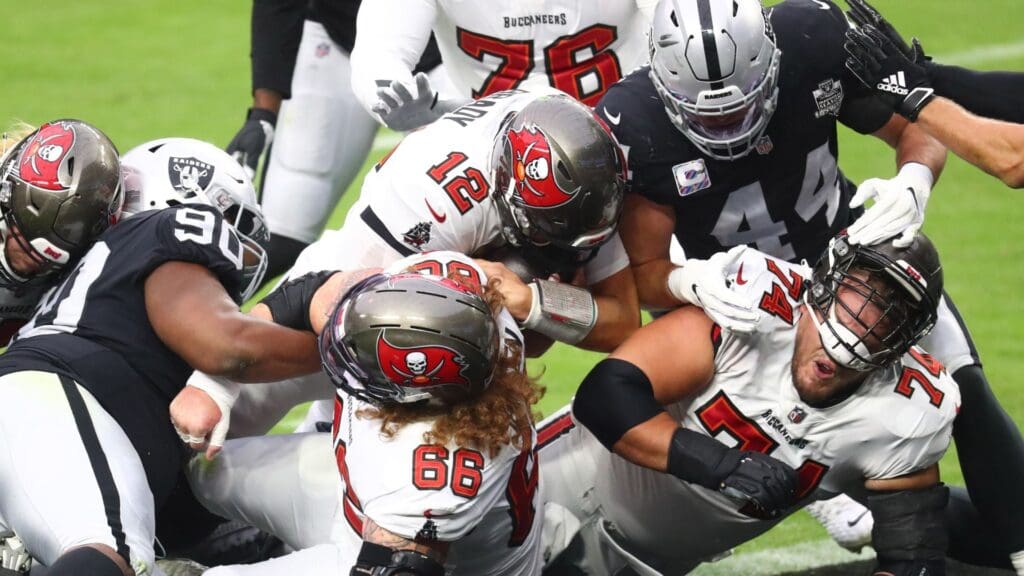 Oct 25, 2020; Paradise, Nevada, USA; Tampa Bay Buccaneers guard Ali Marpet (74) blocks as quarterback Tom Brady (12) pushes into the end zone to score a rushing touchdown against the Las Vegas Raiders in the first quarter at Allegiant Stadium