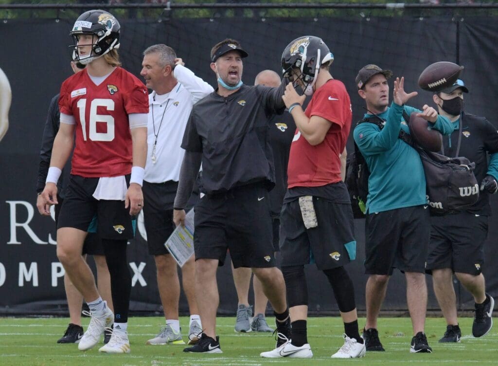 Jaguars Quarterback (16) Trevor Lawrence, Head Coach Urban Meyer, Passing Game Coordinator Brian Schottenheimer and Quarterback (3) C.J. Beathard on the practice fields outside TIAA Bank Field during the Jacksonville Jaguars mandatory veterans minicamp session Monday morning, June 14, 2021. Jki 061421 Jaguarsveteransminicamp 27